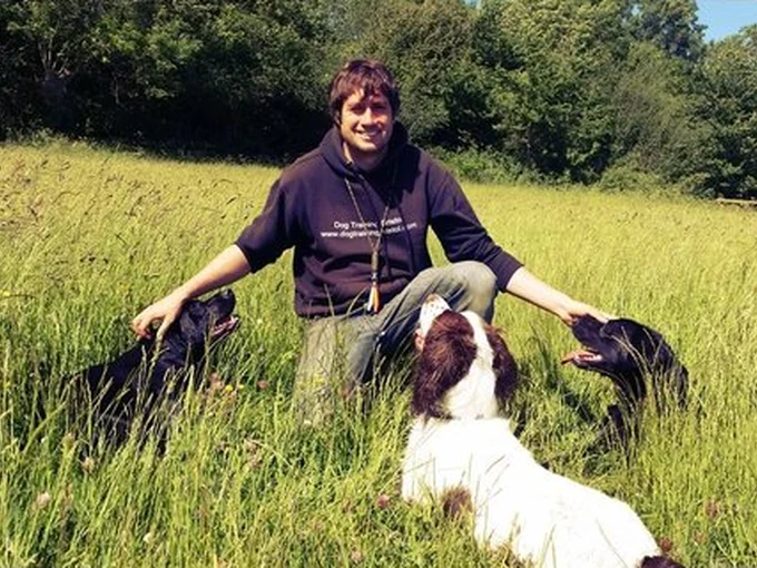 Steve with dogs in the long grass at Woolmers